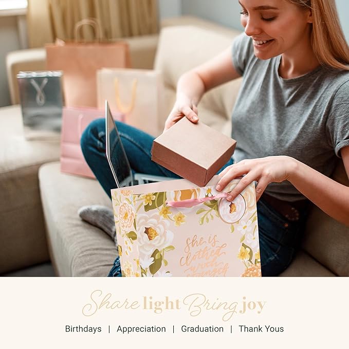 Christian Art Gifts Large Portrait Inspirational Scripture Gift Bag, Tag & Wrapping Tissue Paper Set for Women: Strength & Dignity Encouraging Bible Verse, Satin Ribbon Handles, Pink Multicolor Floral